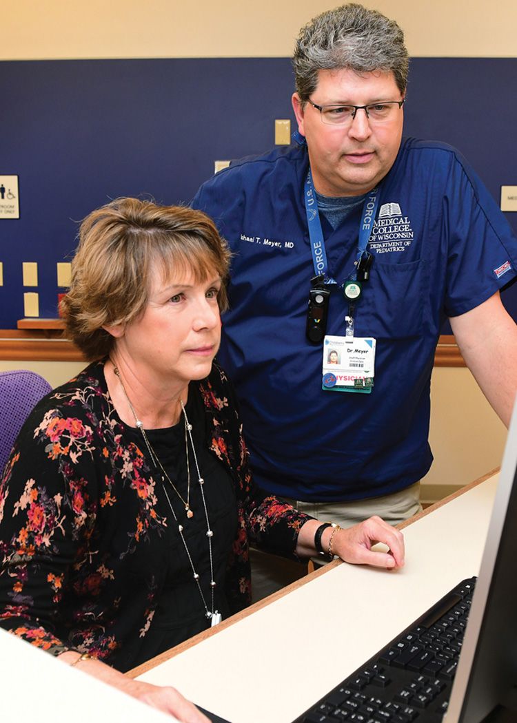 Image of two doctors collaborating at a computer.
