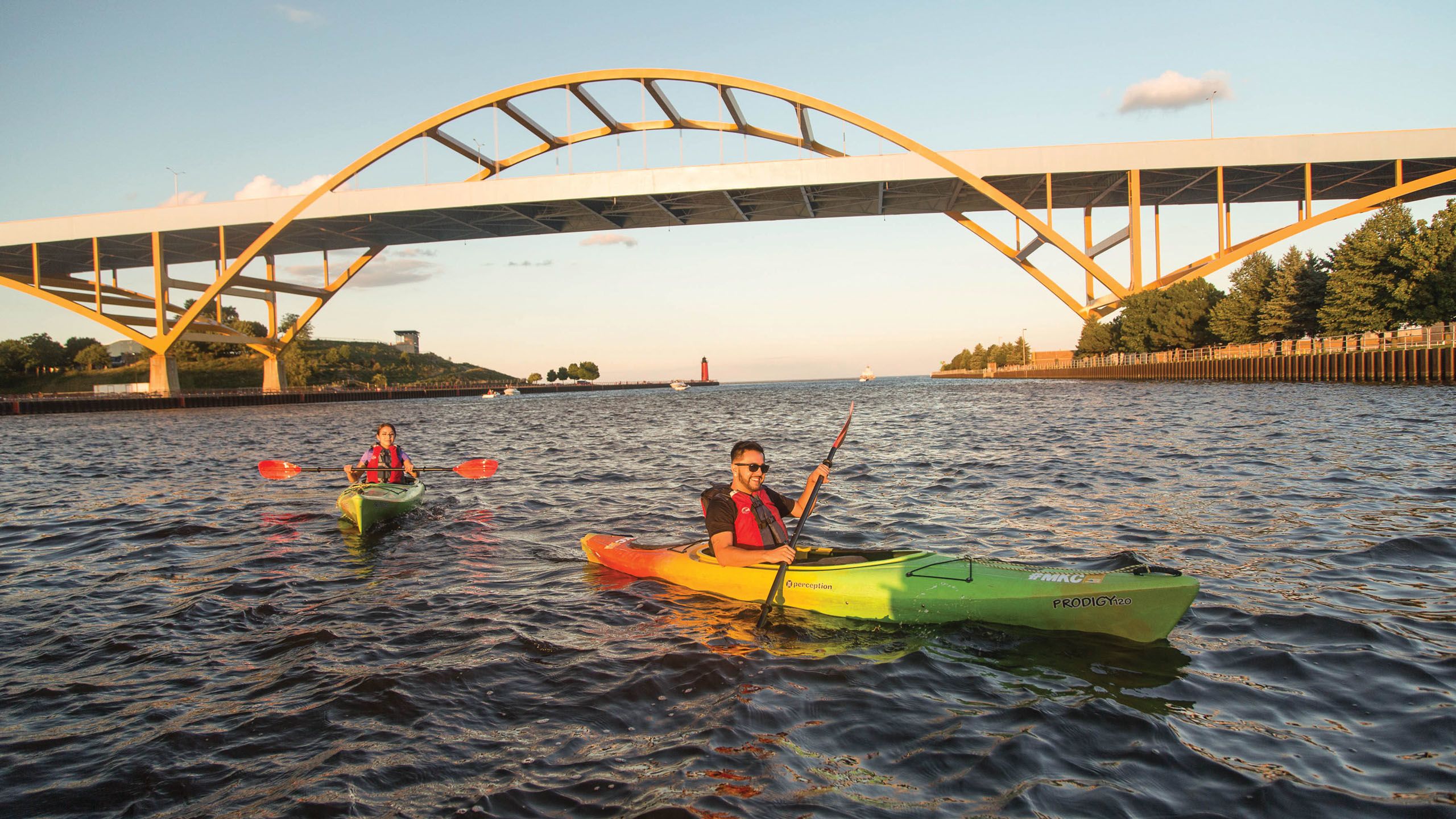 Image of person kayaking under the Hoan Bridge in downtown Milwaukee.