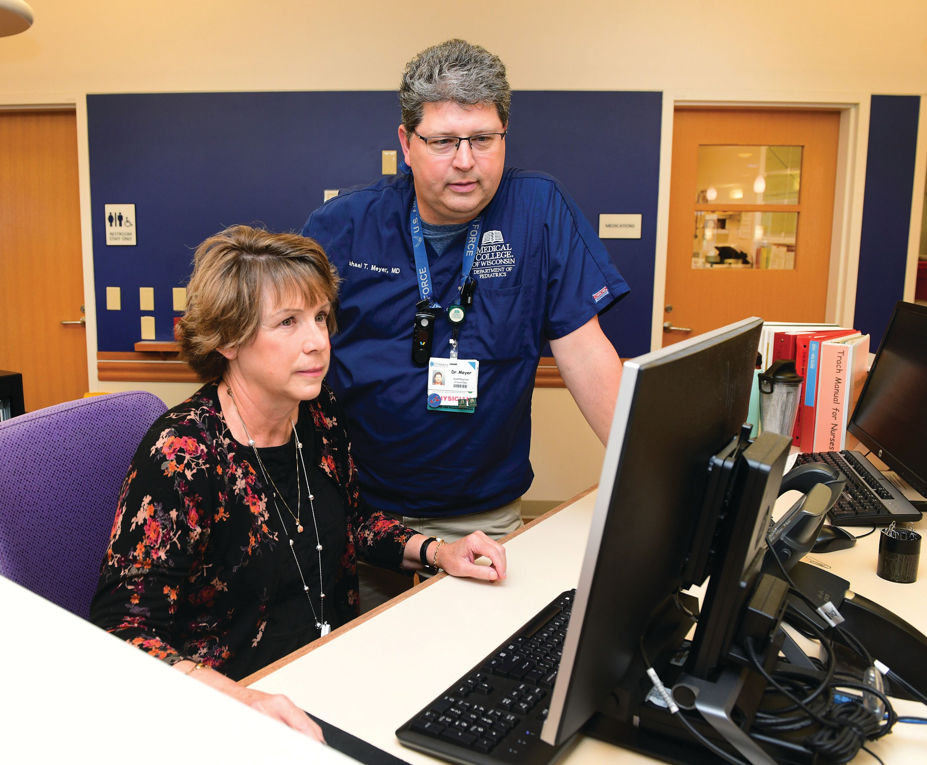 Researcher filling pipette in lab.